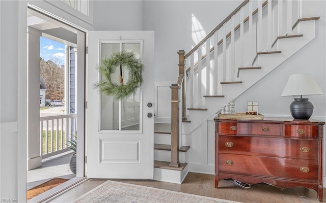 foyer entrance with stairway and wood finished floors