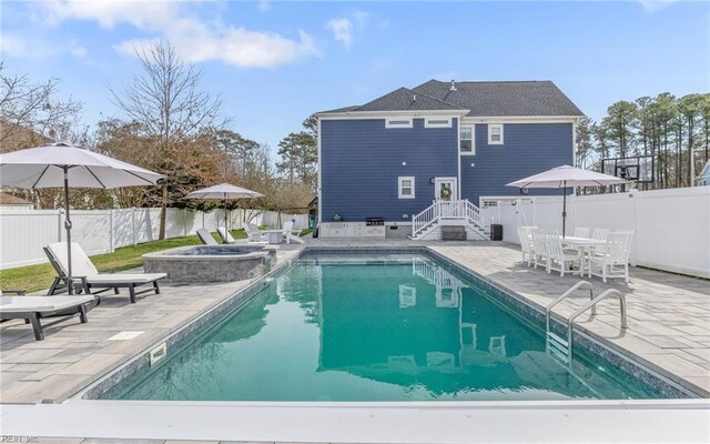 view of pool with outdoor dining space, a patio area, a fenced in pool, and a fenced backyard