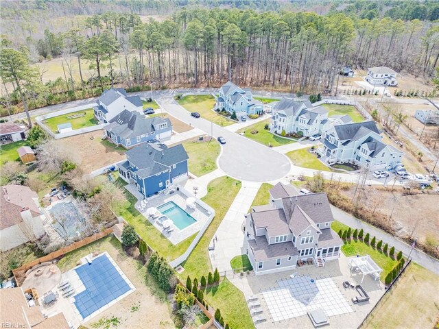 birds eye view of property with a view of trees and a residential view