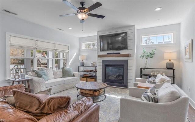 living area featuring visible vents, recessed lighting, a large fireplace, and ceiling fan