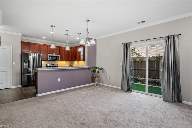 kitchen with dark colored carpet, appliances with stainless steel finishes, and crown molding