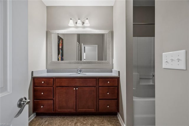 full bath featuring vanity and baseboards