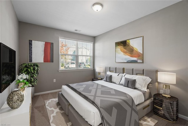 carpeted bedroom featuring visible vents and baseboards