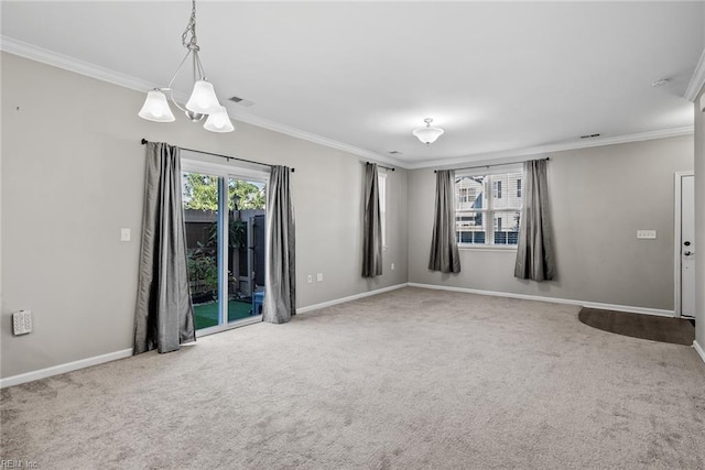 carpeted empty room with visible vents, baseboards, and crown molding