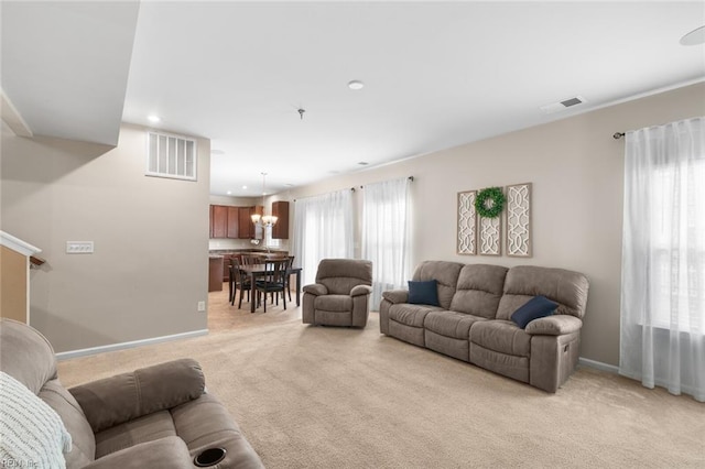 living room featuring light carpet, baseboards, visible vents, and recessed lighting