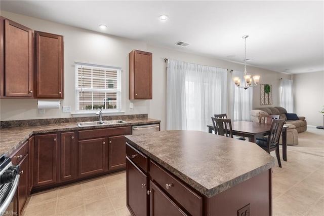 kitchen with visible vents, dark countertops, appliances with stainless steel finishes, open floor plan, and a sink