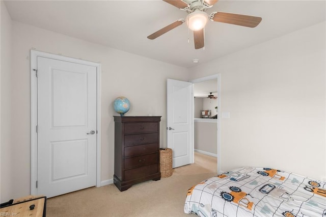 bedroom with light carpet, ceiling fan, and baseboards