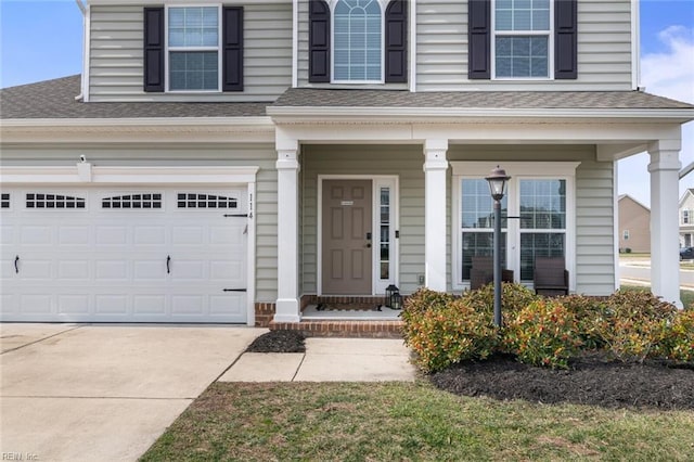 property entrance with a shingled roof, covered porch, and driveway