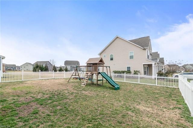 view of playground with a fenced backyard, a residential view, and a lawn