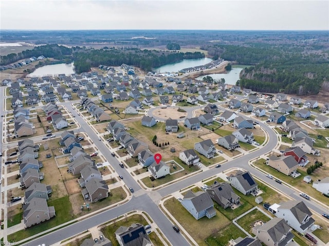 birds eye view of property with a water view and a residential view