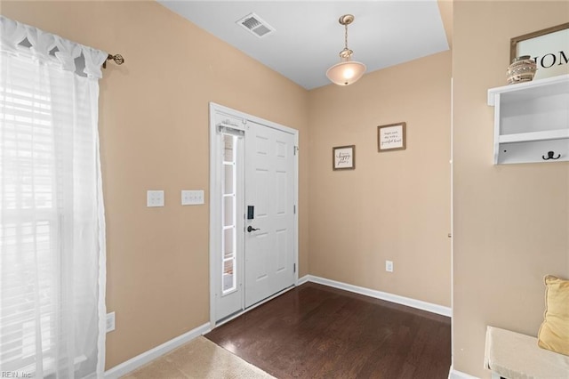 foyer entrance featuring visible vents and baseboards