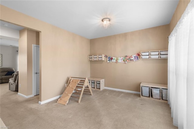 recreation room with carpet floors and baseboards