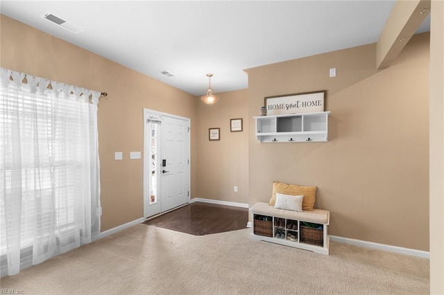 entrance foyer with baseboards, visible vents, and carpet flooring