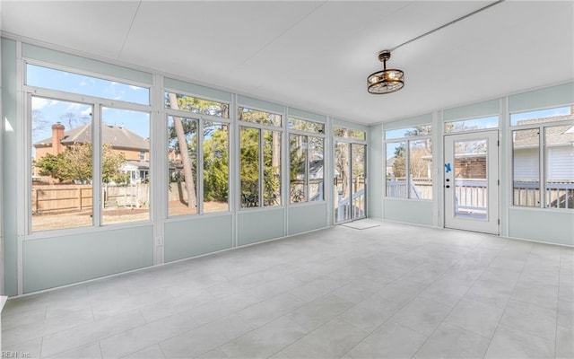 unfurnished sunroom with plenty of natural light