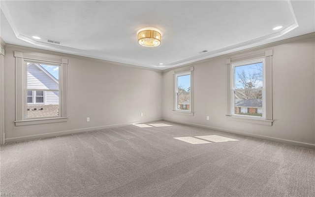 unfurnished room featuring carpet floors, baseboards, a tray ceiling, and crown molding