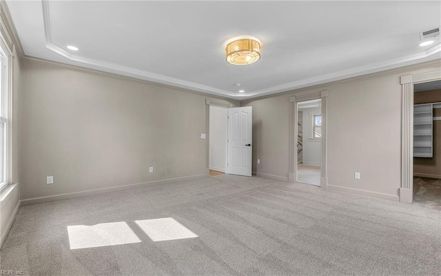 unfurnished bedroom with carpet floors, baseboards, a spacious closet, and visible vents