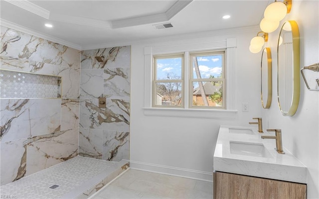 full bathroom featuring visible vents, baseboards, tiled shower, crown molding, and a sink