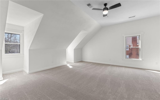 bonus room with lofted ceiling, carpet flooring, visible vents, and baseboards