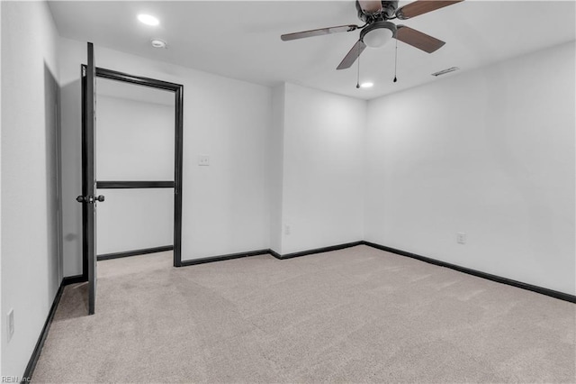 spare room featuring visible vents, baseboards, a ceiling fan, light colored carpet, and recessed lighting