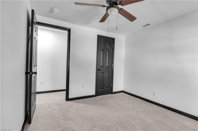 unfurnished bedroom featuring a ceiling fan, visible vents, baseboards, and carpet flooring