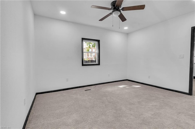 empty room featuring carpet floors, recessed lighting, and baseboards