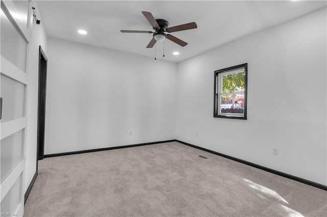 carpeted empty room featuring recessed lighting, a ceiling fan, and baseboards