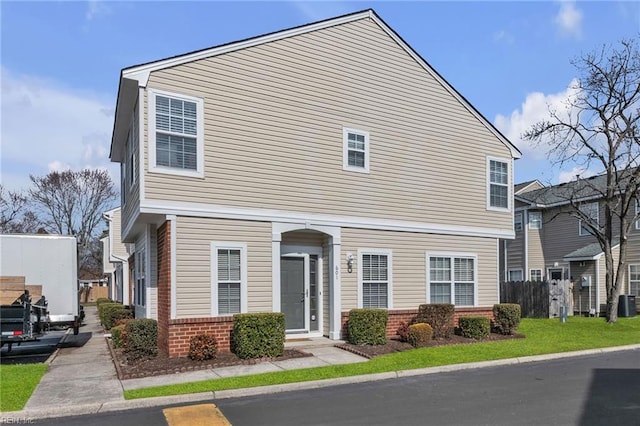 view of front of property featuring brick siding and central AC unit