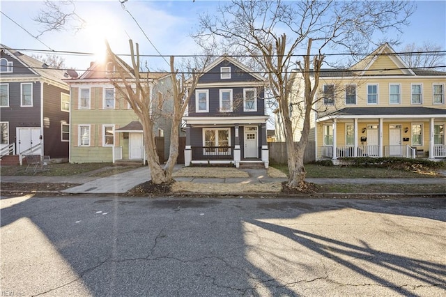 multi unit property with covered porch and a residential view