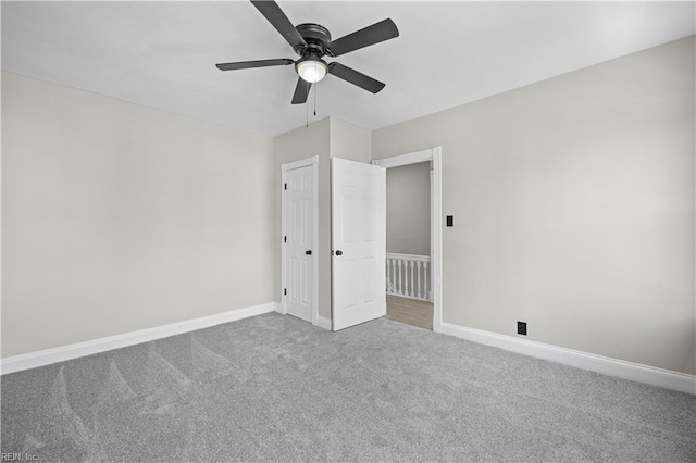 unfurnished bedroom featuring carpet floors, baseboards, and a ceiling fan