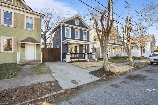 view of front of home featuring a porch and fence