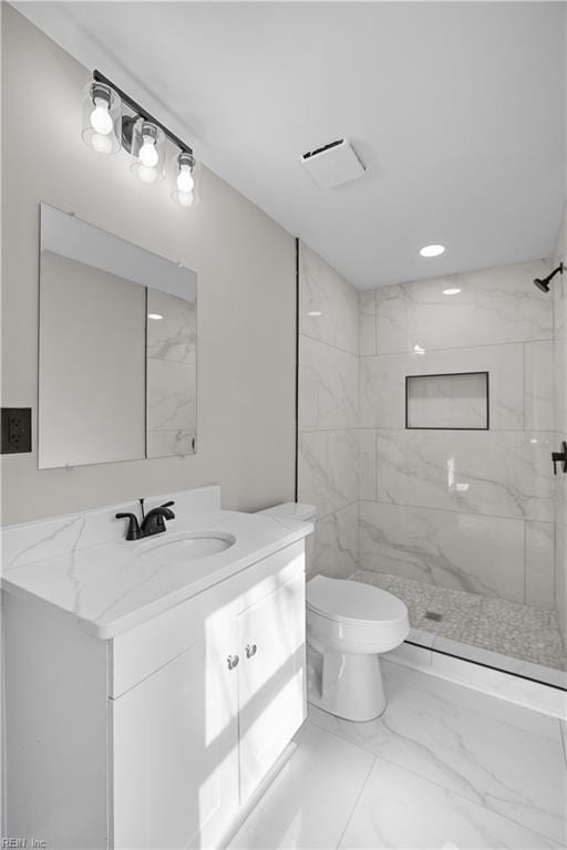 bathroom with marble finish floor, a marble finish shower, visible vents, toilet, and vanity