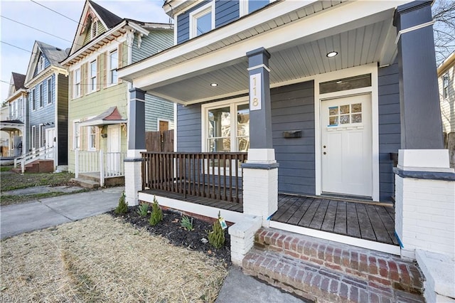 view of exterior entry with covered porch