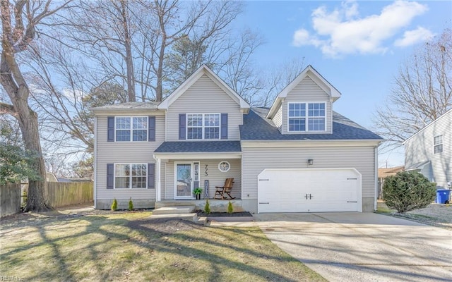 traditional-style home with a garage, fence, concrete driveway, roof with shingles, and a front yard