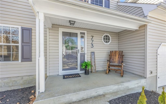 view of exterior entry featuring a porch