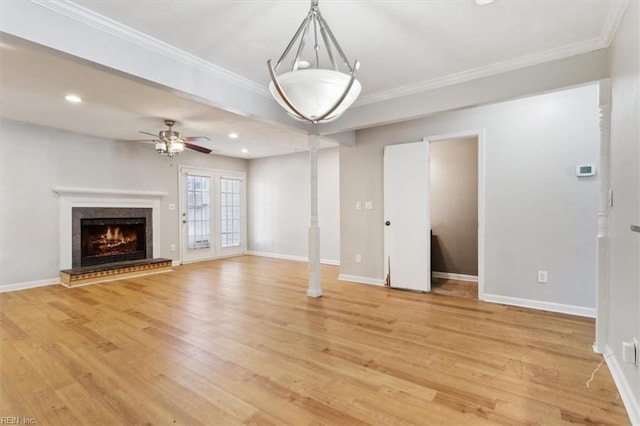 unfurnished living room with baseboards, ornamental molding, recessed lighting, and light wood-style floors