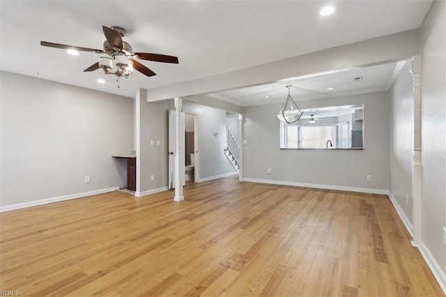 unfurnished living room with recessed lighting, stairway, light wood-type flooring, and baseboards