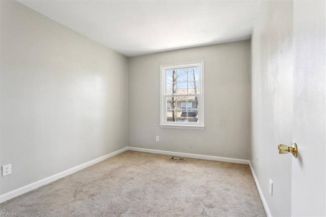 carpeted empty room with baseboards