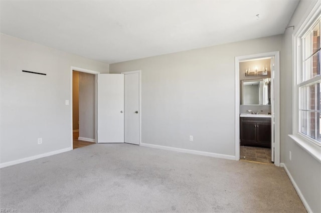 unfurnished bedroom with multiple windows, carpet, and baseboards