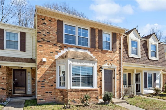 townhome / multi-family property featuring brick siding