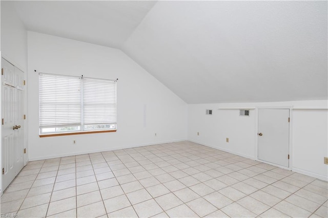 additional living space with lofted ceiling and visible vents