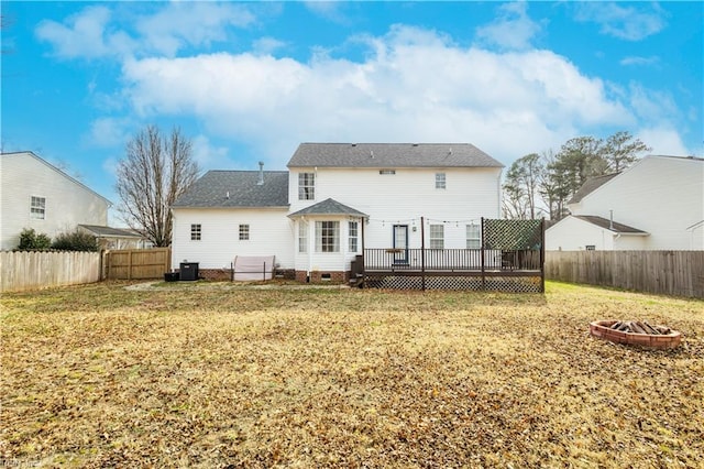 back of house with a fire pit, a deck, crawl space, and a fenced backyard