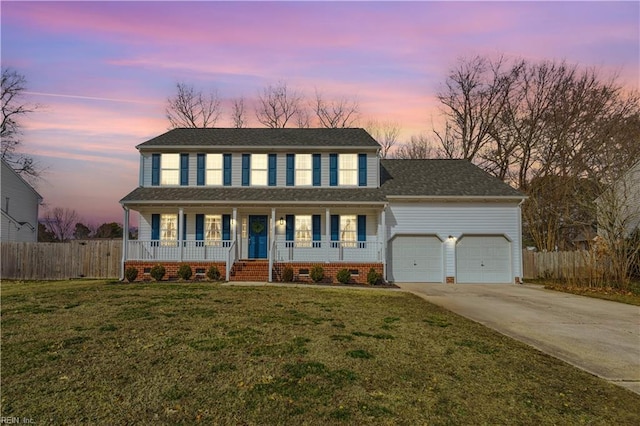 view of front of property featuring a garage, driveway, covered porch, fence, and a front yard