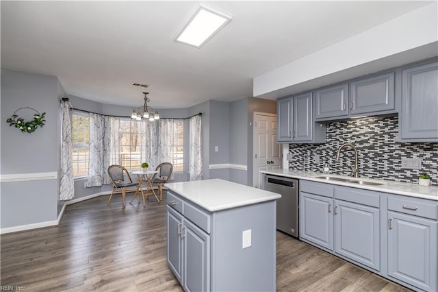 kitchen featuring a sink, gray cabinets, dishwasher, and light countertops