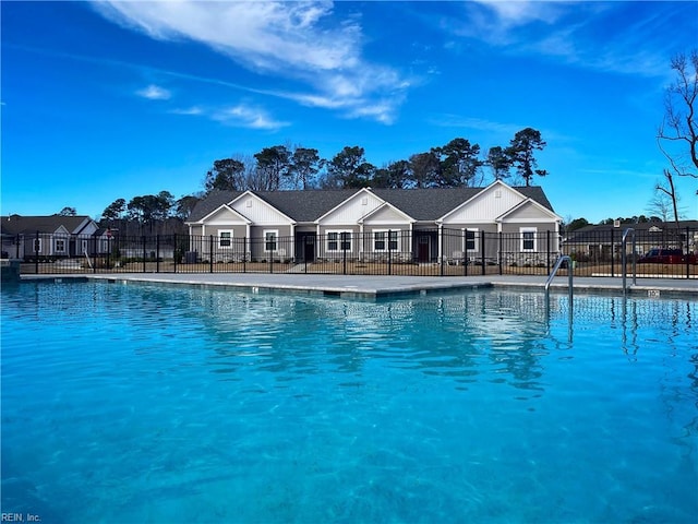 view of pool featuring fence