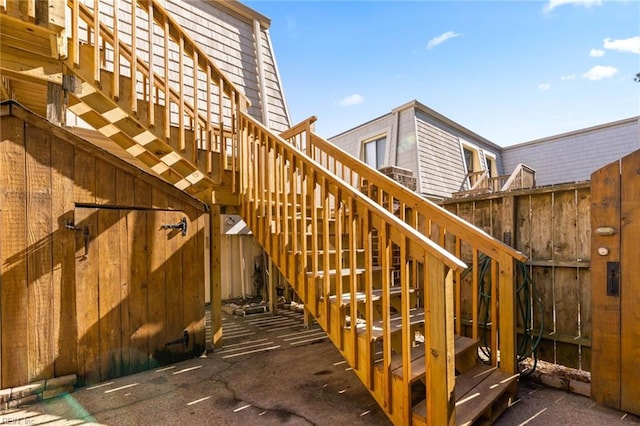 exterior space featuring fence and stairway