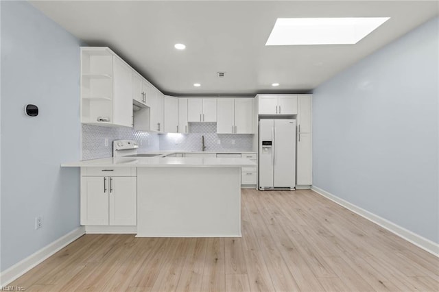 kitchen with open shelves, backsplash, white fridge with ice dispenser, range, and a peninsula