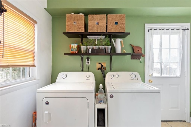 laundry area featuring laundry area, independent washer and dryer, and light tile patterned floors