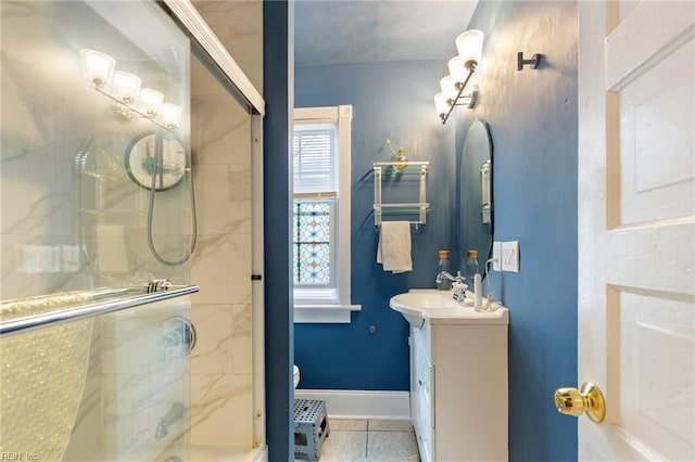 full bathroom featuring a shower with door, toilet, vanity, tile patterned flooring, and baseboards