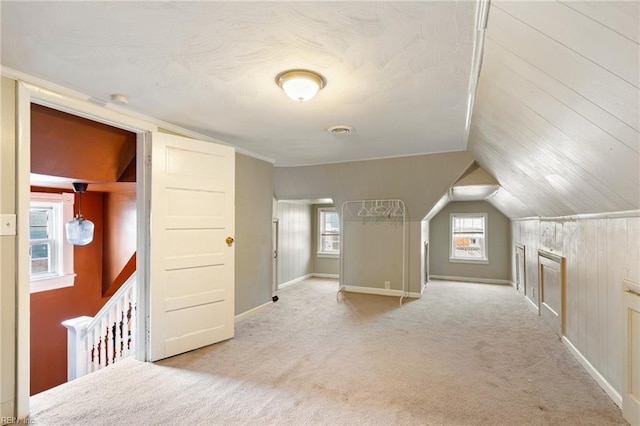 bonus room featuring carpet, visible vents, lofted ceiling, and baseboards