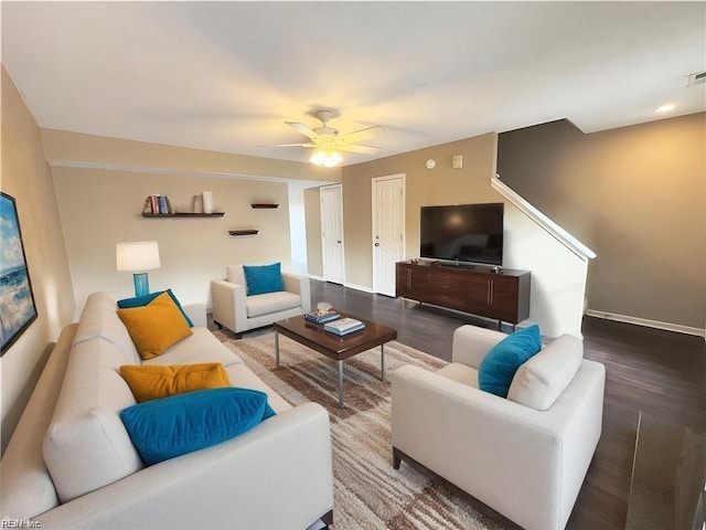 living room featuring visible vents, wood finished floors, a ceiling fan, and baseboards